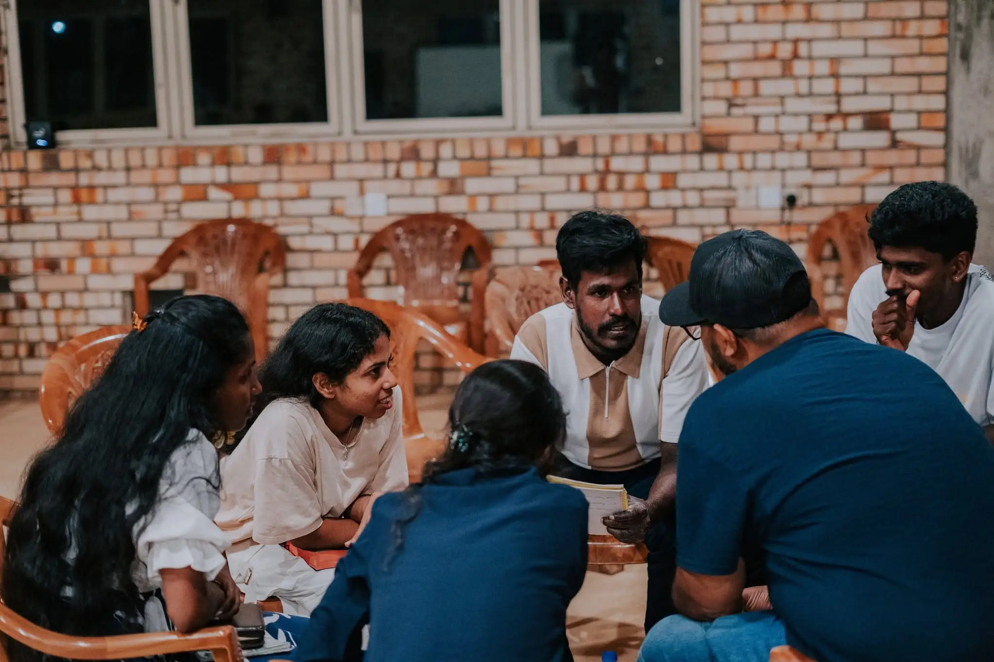 A small group sitting in a circle, talking things through